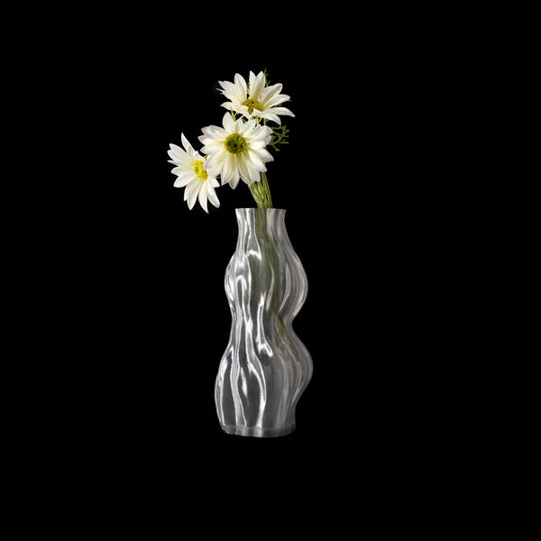 Vase Aria transparent en PETG, garni de fleurs blanches, photographié en studio sur fond noir